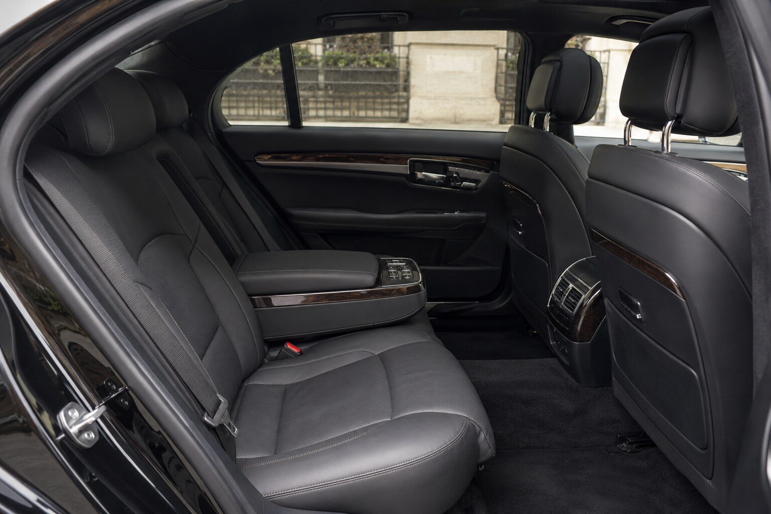 The unoccupied rear cabin of a black executive sedan